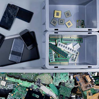 Smartphone circuits and pieces organized in white plastic containers