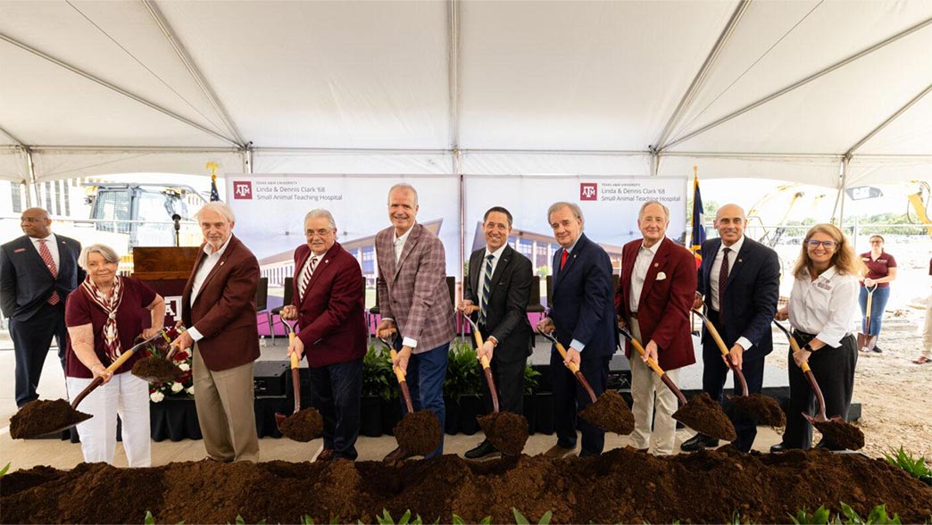 Texas A&M stakeholders and executives stand with shovels to break ground at the construction site for the new animal hospital