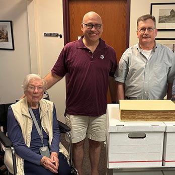 Department of Geography Professor Emerita Clarissa Kimber (left) next to her donation of two rare, historic works that helped lay the foundations for modern geography and expanded how scholars understood and documented the Earth. From left beside Kimber are Dr. David Cairns, professor and department head for the Department of Geography; Curator of Maps George Carhart; and Curator Anton duPlessis.