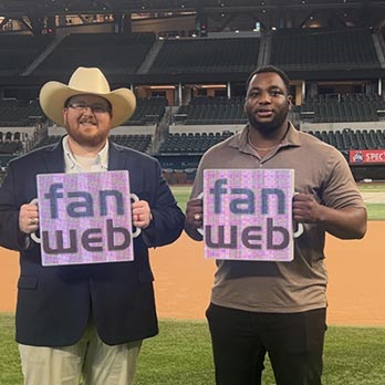 Silhouette of a man standing in the door of a barn on a large ranch, looking off into a bright blue sky.